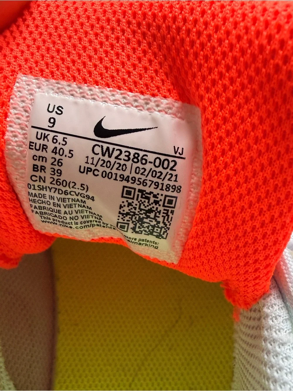Nike Women’s White Athletic Shoes with Neon Yellow and Orange Accents